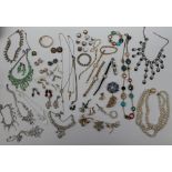 Assorted costume jewellery including faux pearls, brooches,