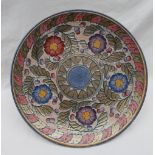 A Crown Ducal pottery charger decorated with purple,