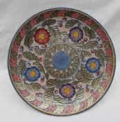 A Crown Ducal pottery charger decorated with purple,