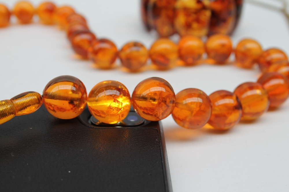 An amber bead necklace with spherical beads together with an expanding bracelet a rotating fob seal - Image 5 of 7