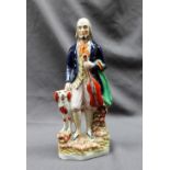 A 19th century pottery figure of the "The Blind Fiddler", with a dog at his heels, 29.