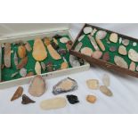 A collection of hardstone tools, including hand axes,