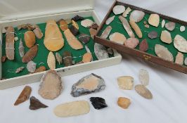 A collection of hardstone tools, including hand axes,