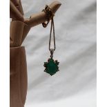 An Emerald pendant the central oval faceted emerald,