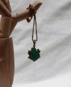 An Emerald pendant the central oval faceted emerald,