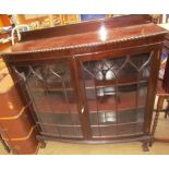 A 20th century mahogany display cabinet with a pair of glazed doors with glazing bars