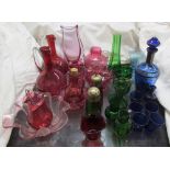 A pair of cranberry glass ewers together with other cranberry glasswares,