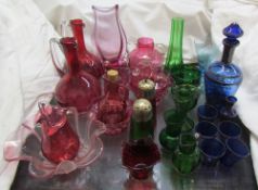 A pair of cranberry glass ewers together with other cranberry glasswares,