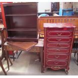 A red lacquer dressing chest with hinged lid and drawers together with a teak table,