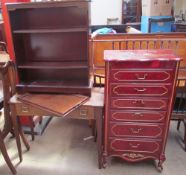 A red lacquer dressing chest with hinged lid and drawers together with a teak table,