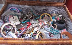 A picnic basket containing assorted costume jewellery including necklaces, bracelets,