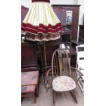 An Ercol rocking chair with swan roundel together with a brass standard lamp and two shades
