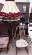 An Ercol rocking chair with swan roundel together with a brass standard lamp and two shades