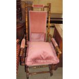 An American rocking chair with pad upholstered back,