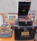 An HMV leatherette covered desk top gramophone together with records and a case