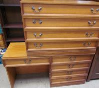 A 20th century teak dressing table and matching chest of drawers