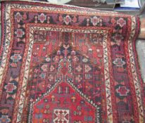 An Iranian rug with a central medallion and geometric pattern