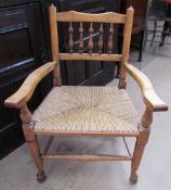 A 19th century spindle back chair with a rush seat on tapering legs,