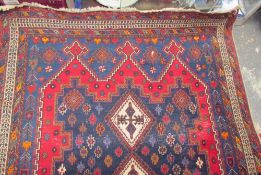 A rug with a blue ground and red mirhabs