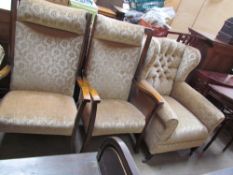 A wing back upholstered arm chair together with a pair of upholstered chairs