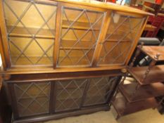 Two oak bookcases with sliding leaded glass doors together with a bookcase