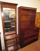 A 20th century hall stand with a central rectangular mirror, brass hooks,