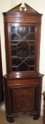 An Edwardian mahogany standing corner cupboard,