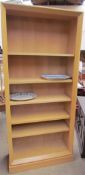 A 20th century oak bookcase with five shelves together with two pottery meat plates