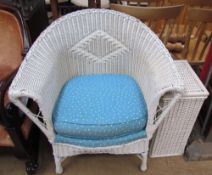 A rattan elbow chair painted white together with a laundry basket