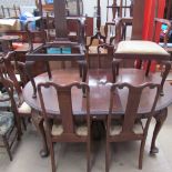 A 20th century mahogany extending dining table together with a set of eight dining chairs