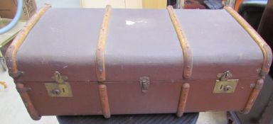 A banded trunk together with a wicker coffee table