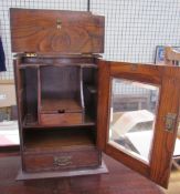 A smokers cabinet with a glazed door and base drawer