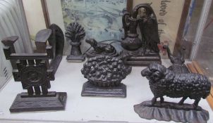 A cast iron sheep door stop together with other door stops,