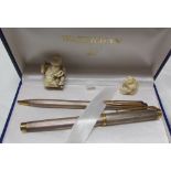 A white and yellow metal Waterman fountain pen, with matching rollerball, boxed,