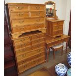 A large modern pine chest of drawers together with a smaller example, a dressing table, mirror,