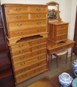 A large modern pine chest of drawers together with a smaller example, a dressing table, mirror,