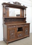 A late 19th century Low Countries carved oak mirrorback sideboard,