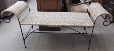 A rattan and wrought iron bench