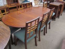 A reproduction mahogany extending dining table together with seven chairs and a sideboard