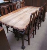 An early 20th century continental dining table with a shaped top on cabriole legs and claw and ball