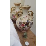 A pair of bird decorated pottery twin handled vases,