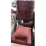 A reproduction mahogany half round chest of drawers together with a half round table and an