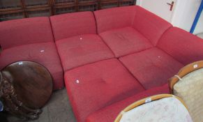 A red modular upholstered settee in five sections