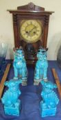 An oak cased mantle clock together with pottery dogs of foo