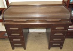 An early 20th century oak desk with a tambour front,