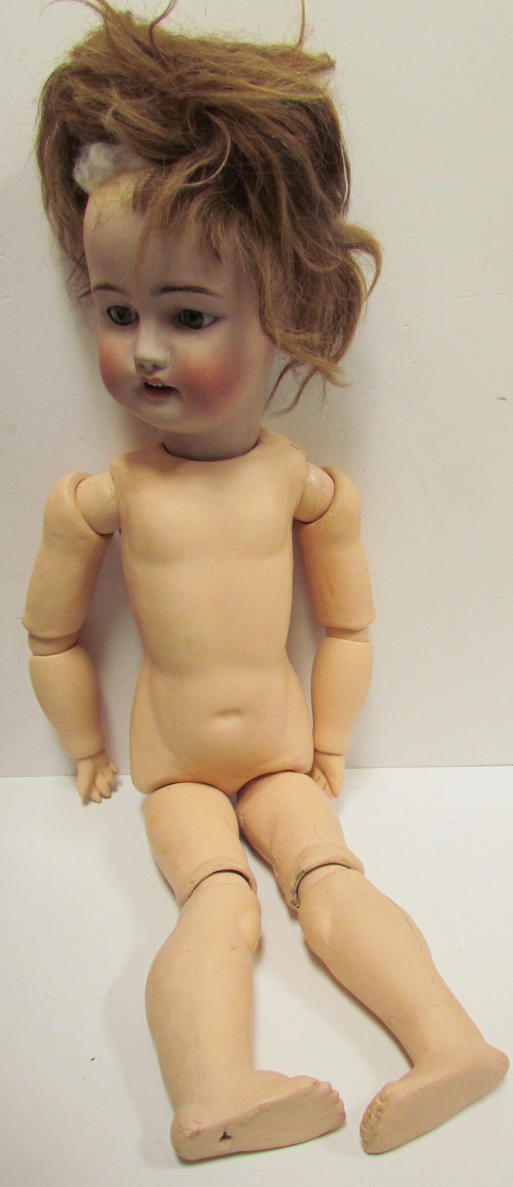 A Simon & Halbig 1078, bisque head doll, with closing blue eyes, open mouth and teeth,