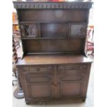 A 20th century oak dresser, the rack with glazed cupboards and shelves,