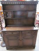 A 20th century oak dresser, the rack with glazed cupboards and shelves,