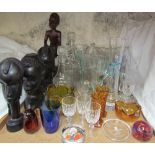 Assorted African carvings together with glass decanters, glass jugs,