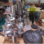 A stainless steel part tea set together with other stainless steel items,